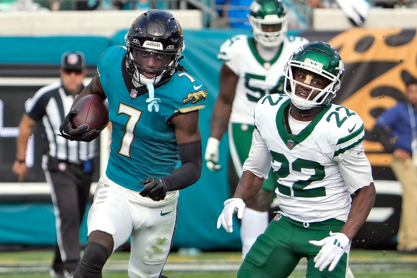 Jacksonville Jaguars wide receiver Brian Thomas Jr. (7) runs past New York Jets safety Tony Adams (22) after a catch during the second half of an NFL football game Sunday, Dec. 15, 2024, in Jacksonville, Fla. (AP Photo/John Raoux)