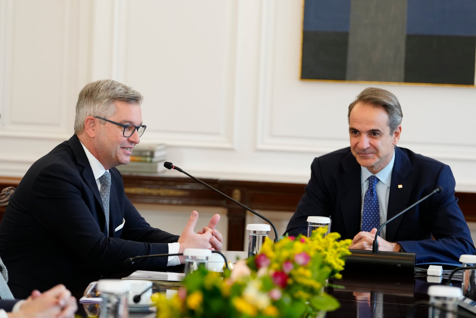 The European Union's new commissioner for migration, Magnus Brunner, left, speaks with Greece's Prime Minister Kyriakos Mitsotakis during their discussions on Europe's migration pact and border protections in Athens, Thursday, Jan. 16, 2025. (AP Photo/Petros Giannakouris)