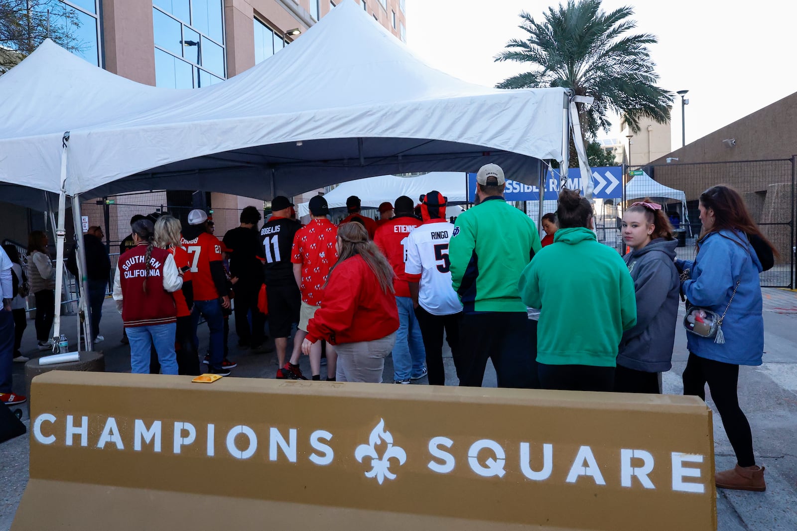 Fans pass through security check points as they enter the Superdome fan zone ahead of the Sugar Bowl NCAA College Football Playoff game, Thursday, Jan. 2, 2025, in New Orleans. (AP Photo/Butch Dill)