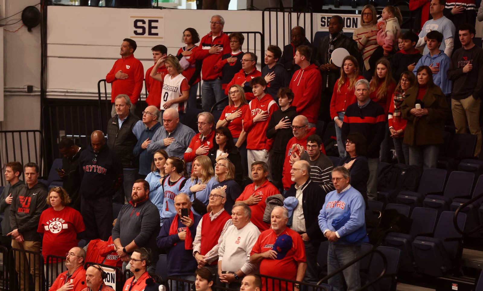 Dayton fans stand for the national anthem before a game against George Washington on Saturday, Jan. 4, 2025, at the Charles E. Smith Center in Washington, D.C. David Jablonski/Staff