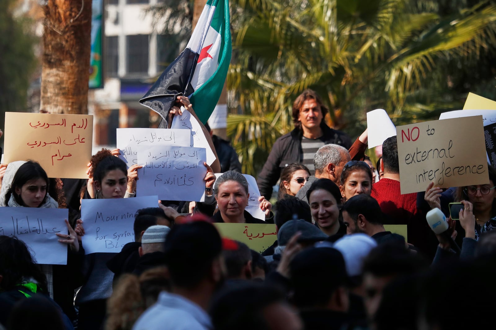 Activists demonstrate against violence in the coastal region of Damascus, Syria, Sunday, March 9, 2025. (AP Photo/Omar Sanadiki)