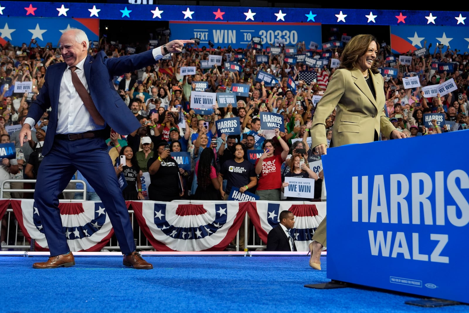 Democratic presidential nominee Vice President Kamala Harris and running mate Minnesota Gov. Tim Walz arrive during a campaign rally at Desert Diamond Arena, Friday, Aug. 9, 2024, in Glendale, Ariz. (AP Photo/Julia Demaree Nikhinson)