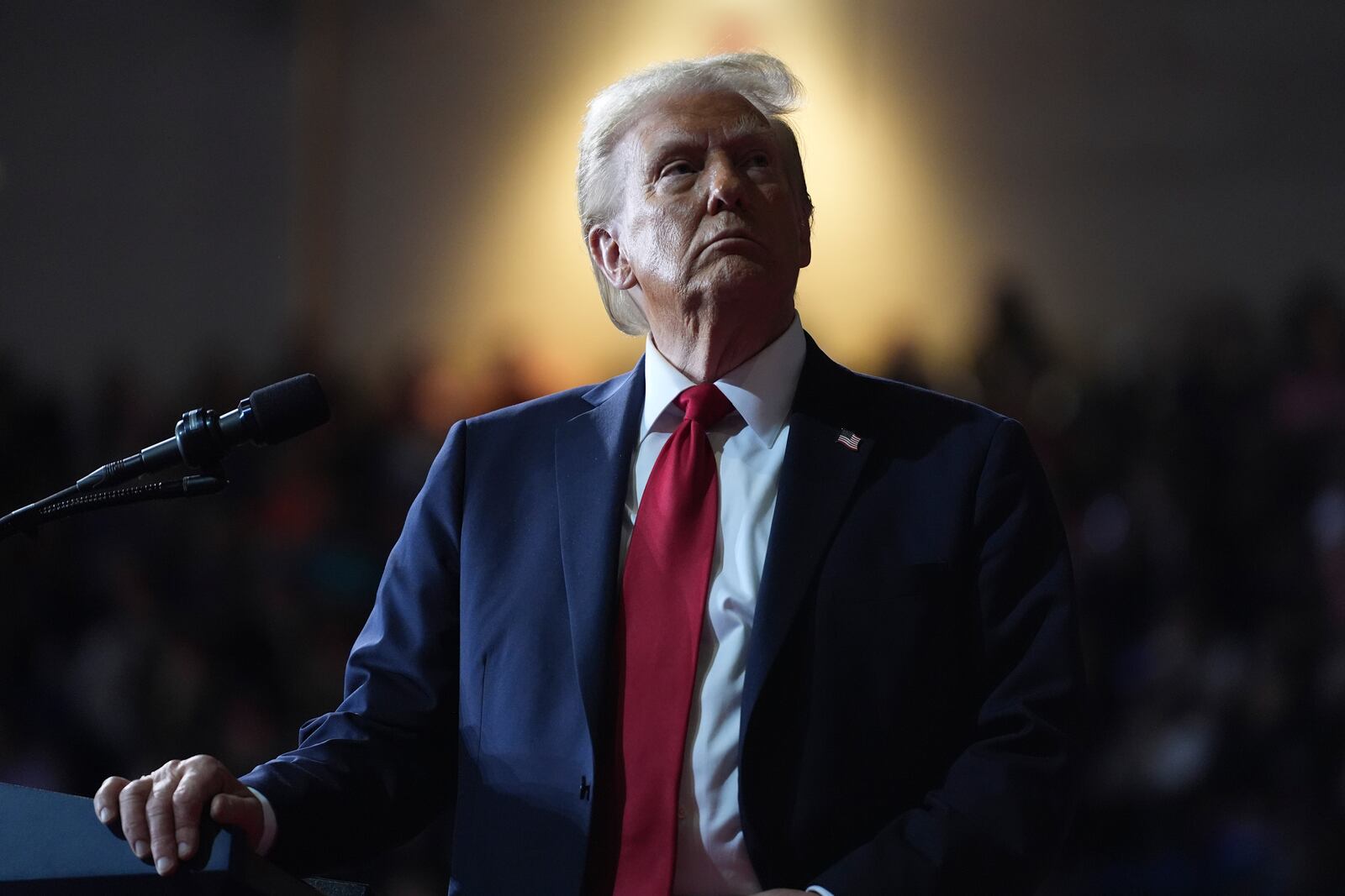 FILE - Republican presidential nominee former President Donald Trump watches a video screen at a campaign rally at the Salem Civic Center, in Salem, Va, Nov. 2, 2024. (AP Photo/Evan Vucci, File)