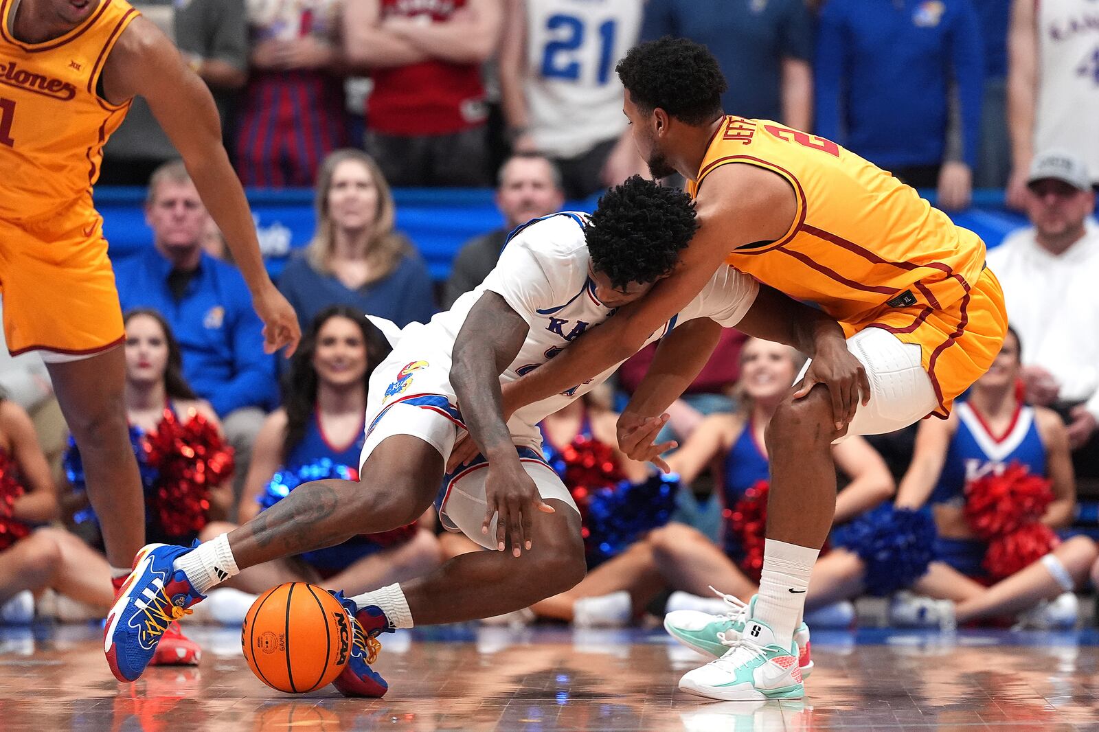 Iowa State forward Joshua Jefferson, right, knocks the ball away from Kansas forward KJ Adams(24) during the first half of an NCAA college basketball game, Monday, Feb. 3, 2025, in Lawrence, Kan. (AP Photo/Charlie Riedel)