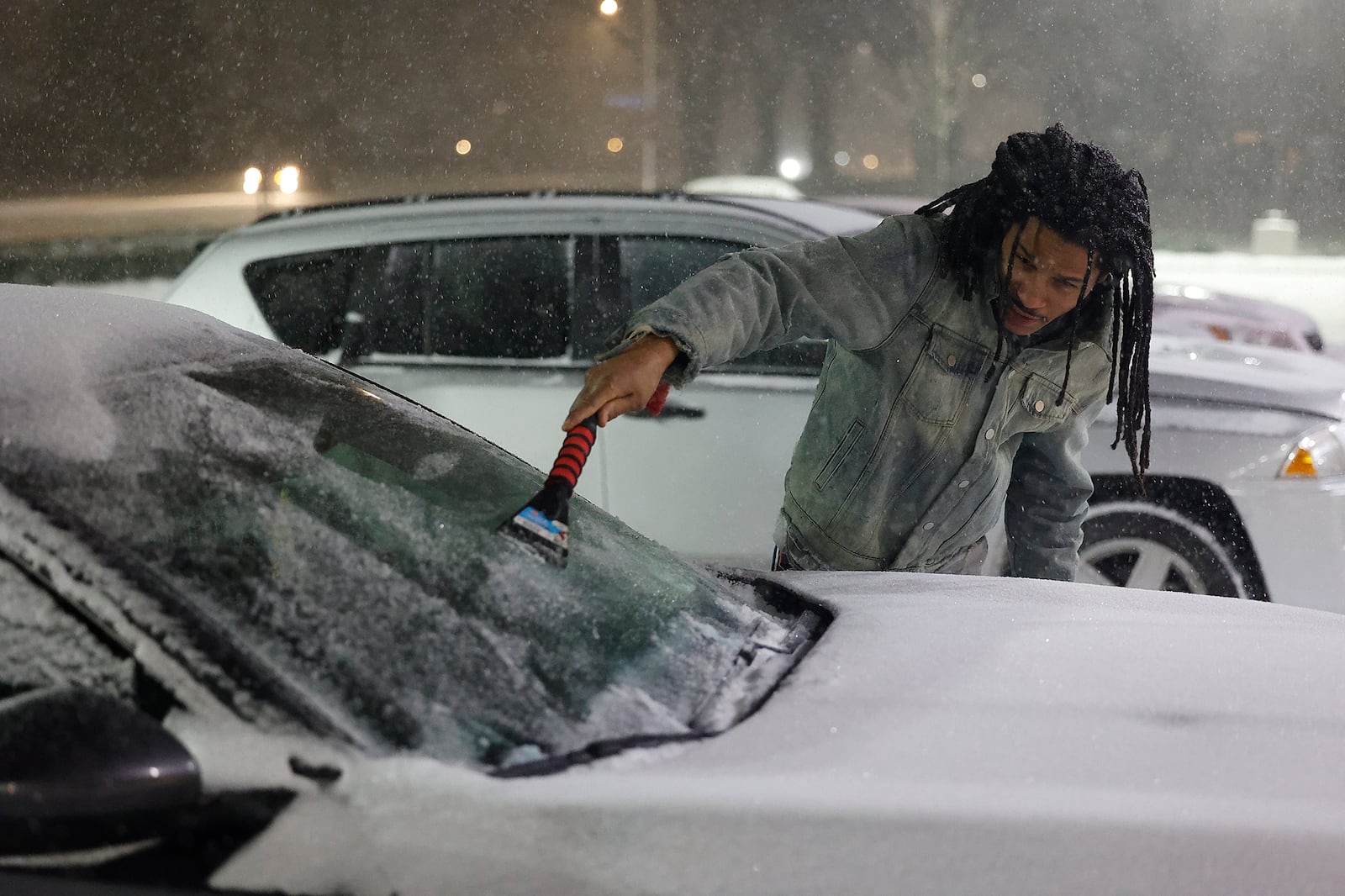 Jefferey Coleman cleans off his car in a parking lot along Taylorsville Road in Huber Heights Sunday evening. BILL LACKEY/STAFF