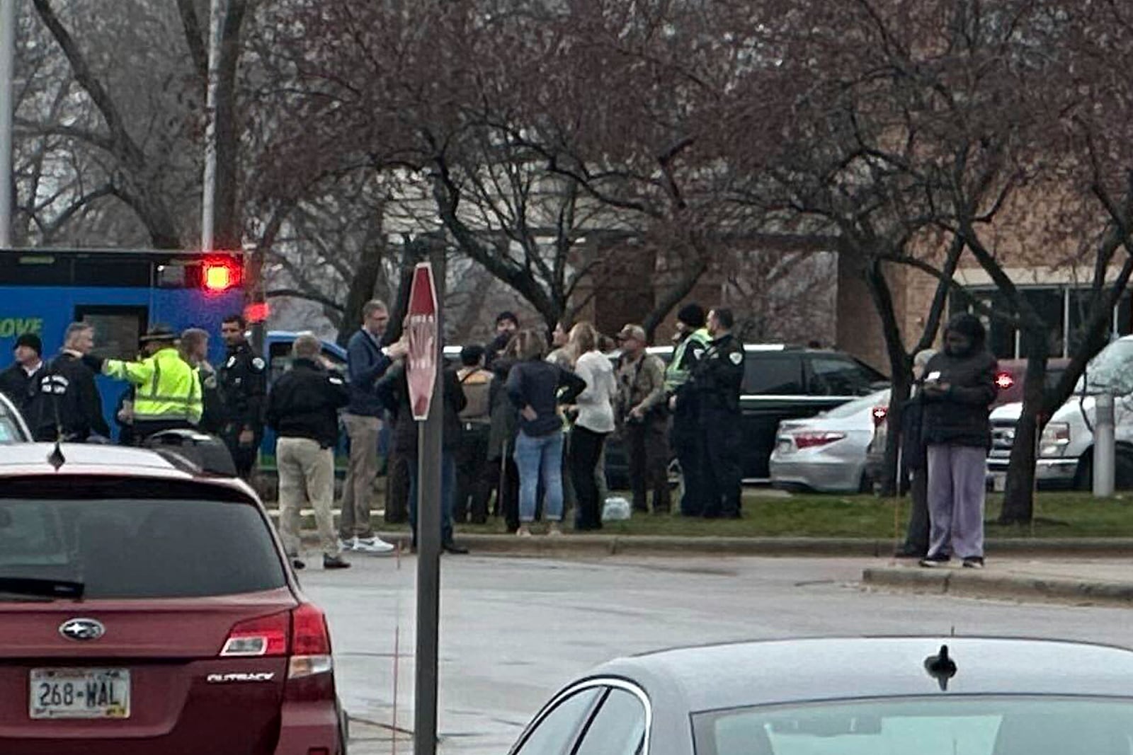 Emergency vehicles are parked outside of the SSM Health clinic where parents are being reunified with children after a shooting at the Abundant Life Christian School in Madison, Wis., Monday, Dec. 16, 2024. (AP Photo/Scott Bauer)