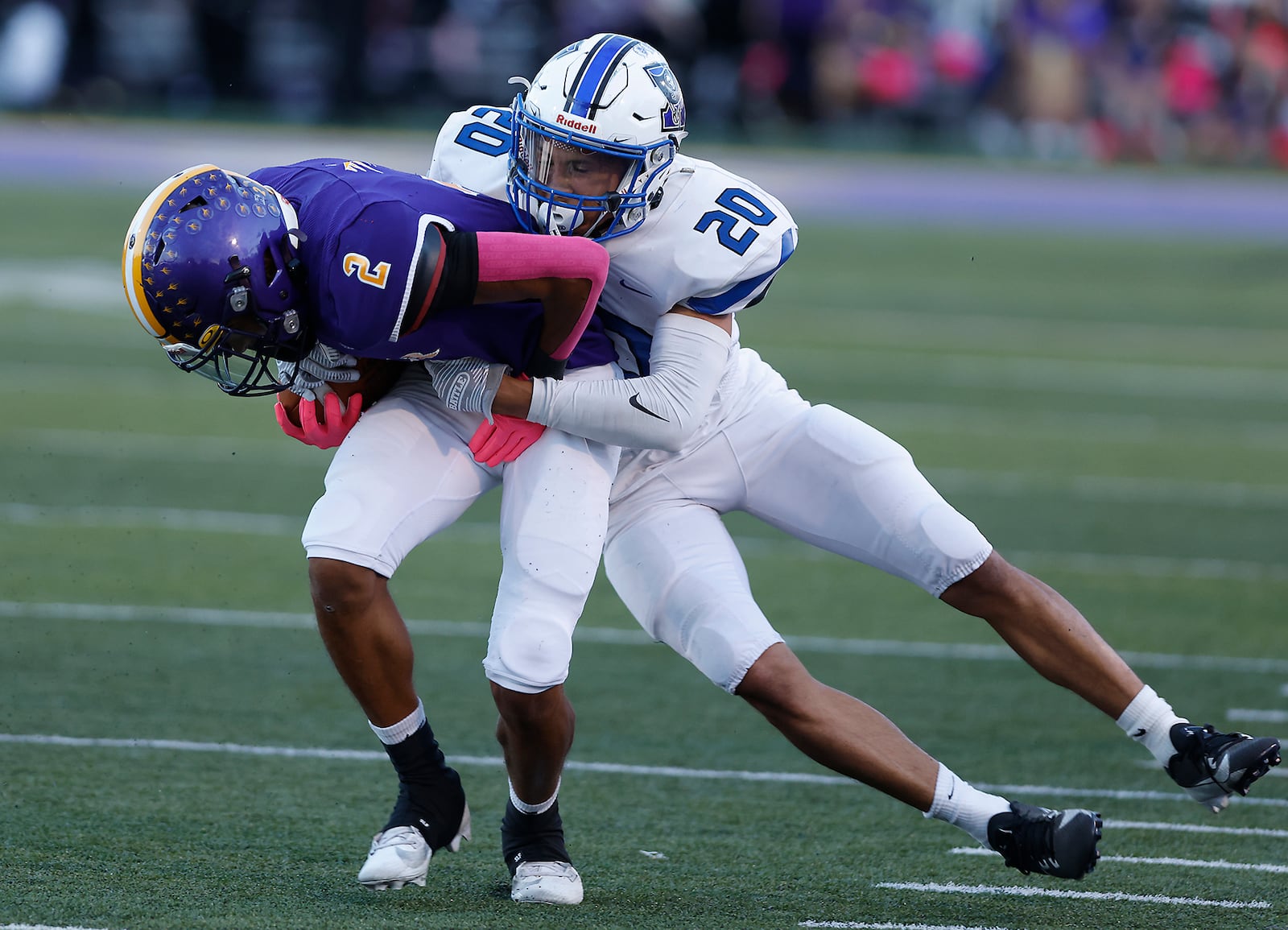 Butler's Tayven Crump is tackled by Xenia's Trimonde Henry after catching a pass. BILL LACKEY/STAFF