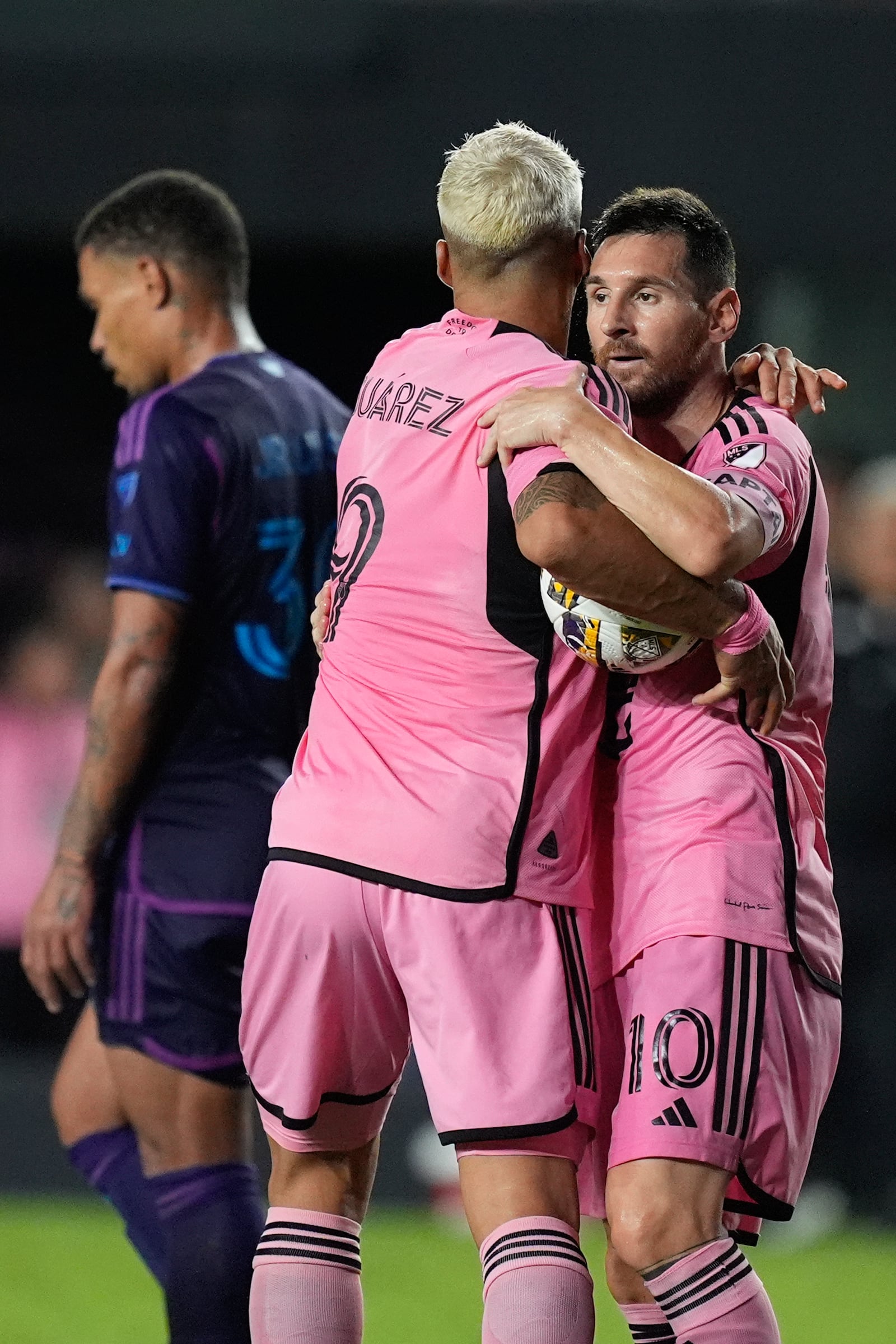 Inter Miami forward Lionel Messi, right, celebrates with forward Luis Suárez (9) after scoring against Charlotte FC during the second half of an MLS soccer match, Saturday, Sept. 28, 2024, in Fort Lauderdale, Fla. (AP Photo/Rebecca Blackwell)