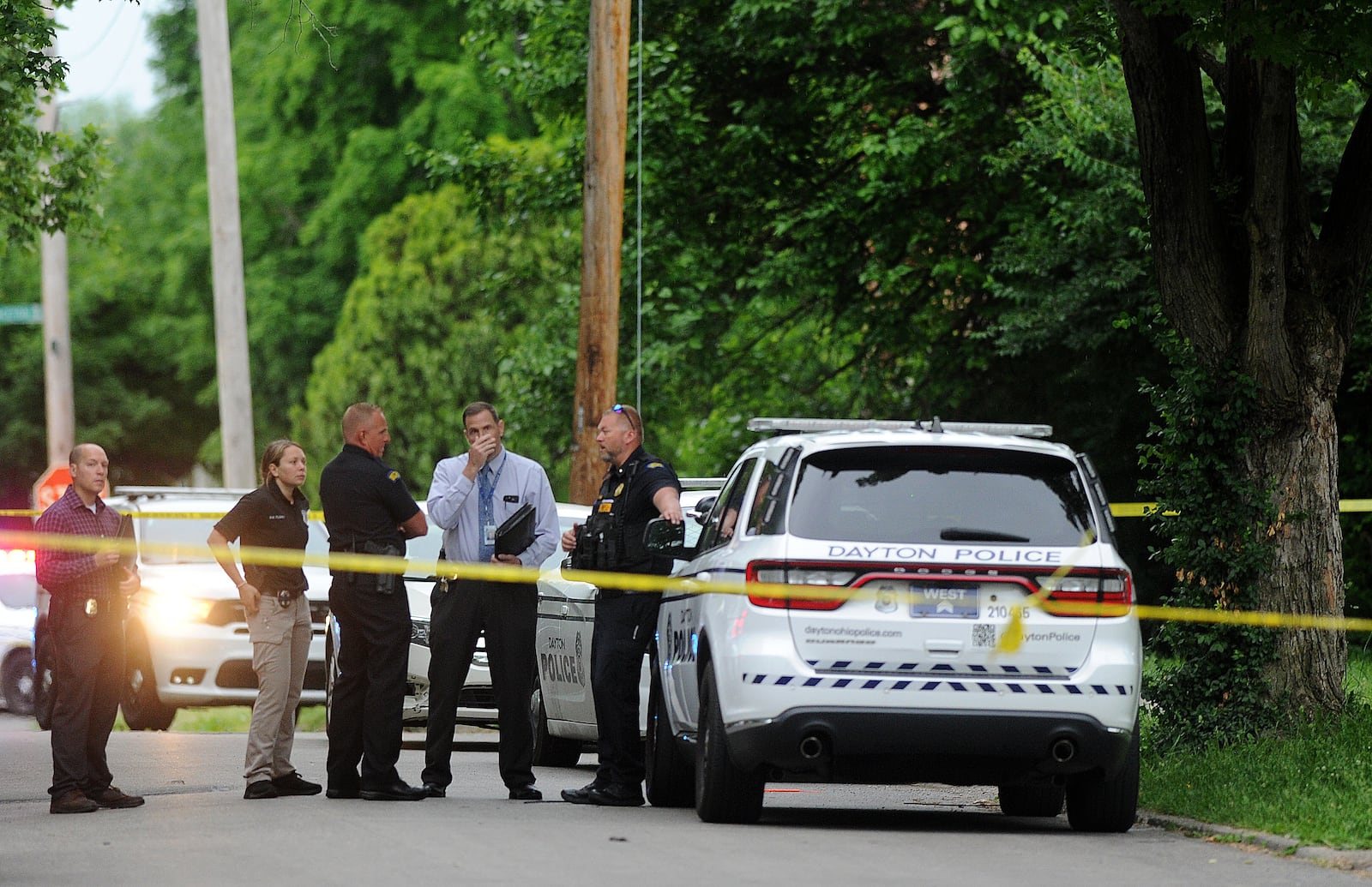 Members of the Dayton Police Department stand outside a house in the 1400 block of Shaftesbury Road early Wednesday morning, May 22, 2024. A woman and teen boy were killed after a shooting inside the home. MARSHALL GORBY\STAFF