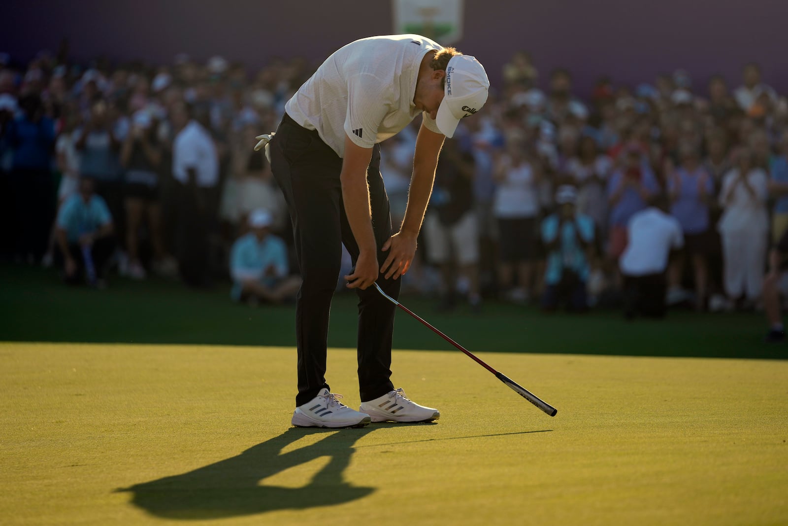 Rasmus Højgaard of Denmark reacts after missing a shot on the 18th hole in the final round of World Tour Golf Championship in Dubai, United Arab Emirates, Sunday, Nov. 17, 2024. (AP Photo/Altaf Qadri)