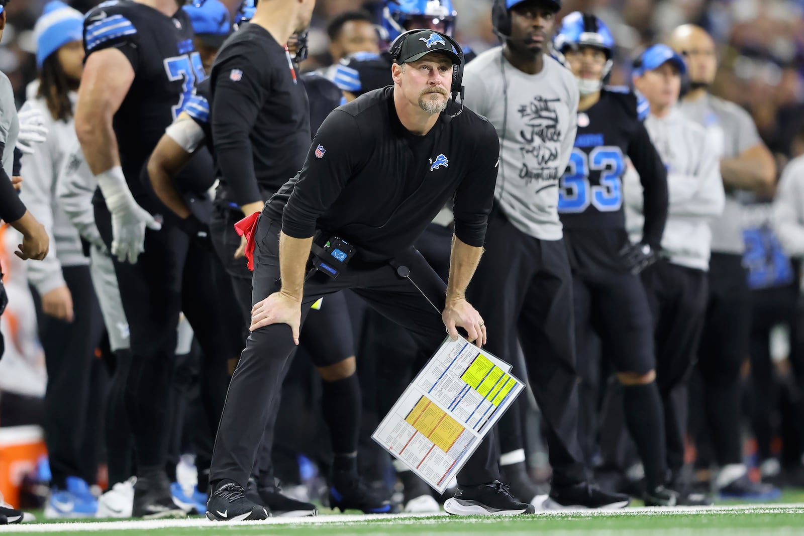 Detroit Lions head coach Dan Campbell, foreground, watches from the sideline during the first half of an NFL football game against the Buffalo Bills, Sunday, Dec. 15, 2024, in Detroit. (AP Photo/Rey Del Rio)