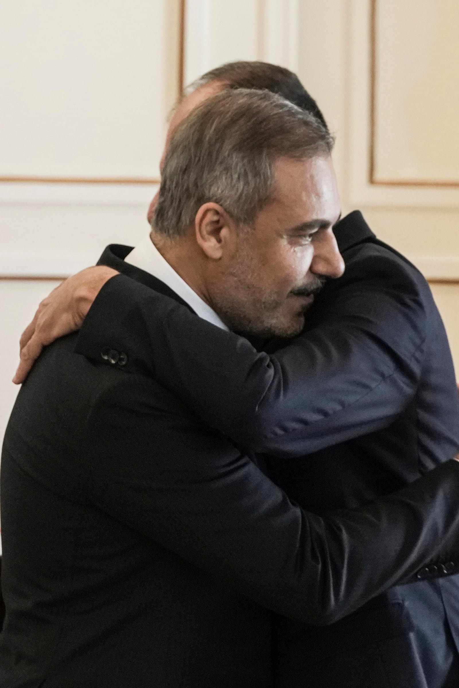 Greek Foreign Minister George Gerapetritis, right and his Turkish counterpart Hakan Fidan hug at the end of a join news conference, in Athens, Greece, Friday, Nov. 8, 2024. (AP Photo/Thanassis Stavrakis)