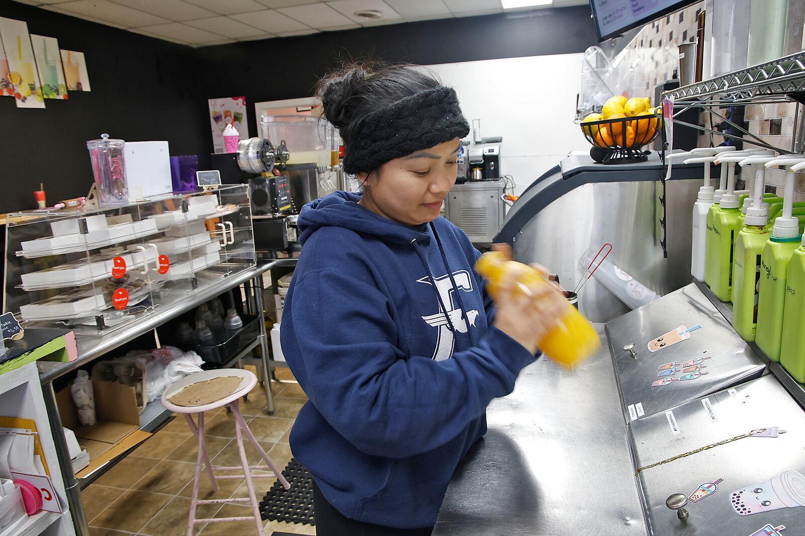 Saolin Nal shakes up a fruit tea she was making for a customer Wednesday, Jan. 24, 2024 at the XO Boba & Tea on Upper Valley Pike. BILL LACKEY/STAFF