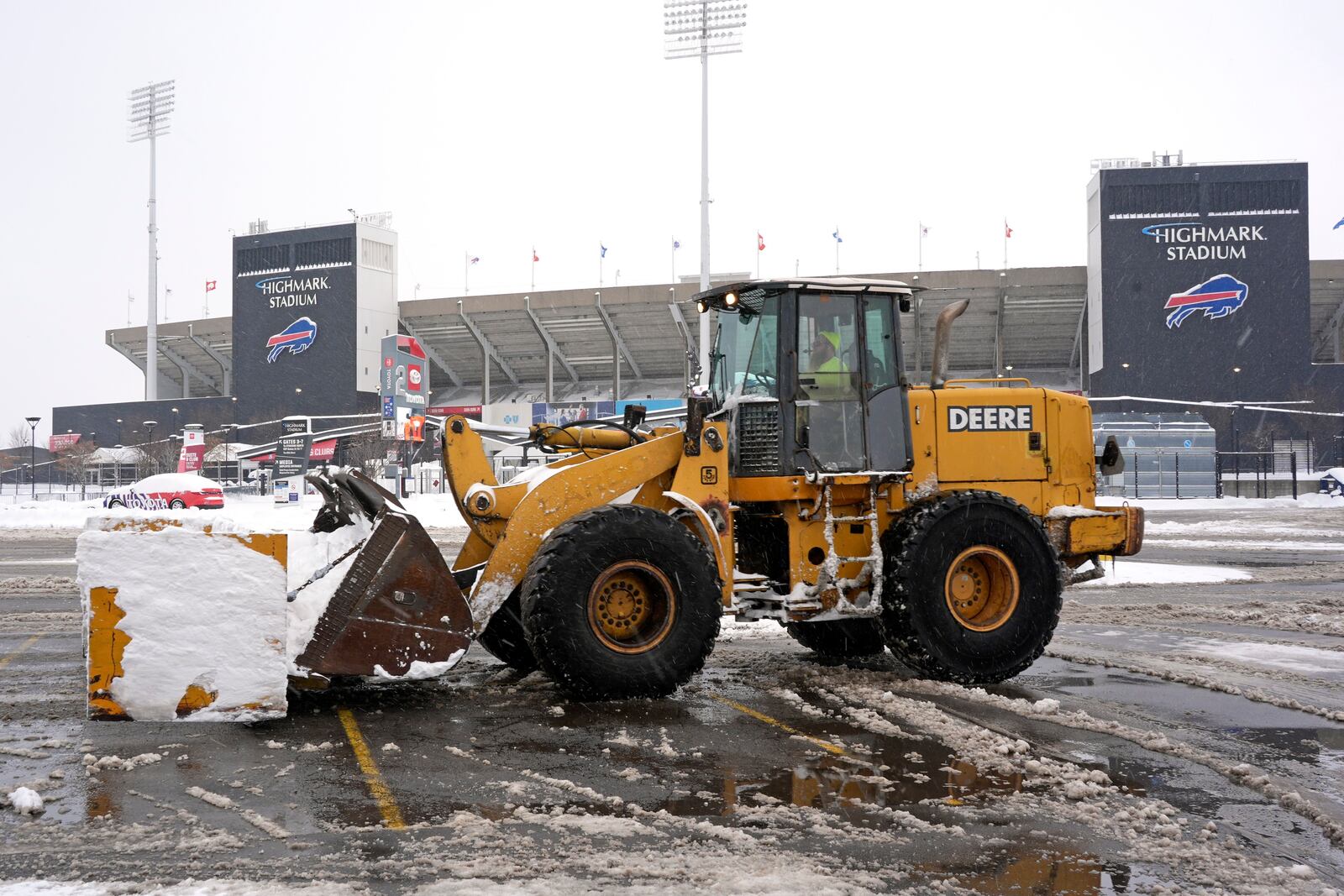 Snow is cleared from a Highmark Stadium parking lot for a Sunday Night Football game between the Buffalo Bills and the San Francisco 49ers on Sunday, Dec. 1, 2024 in Orchard Park, N.Y. (AP Photo/Gene J. Puskar)