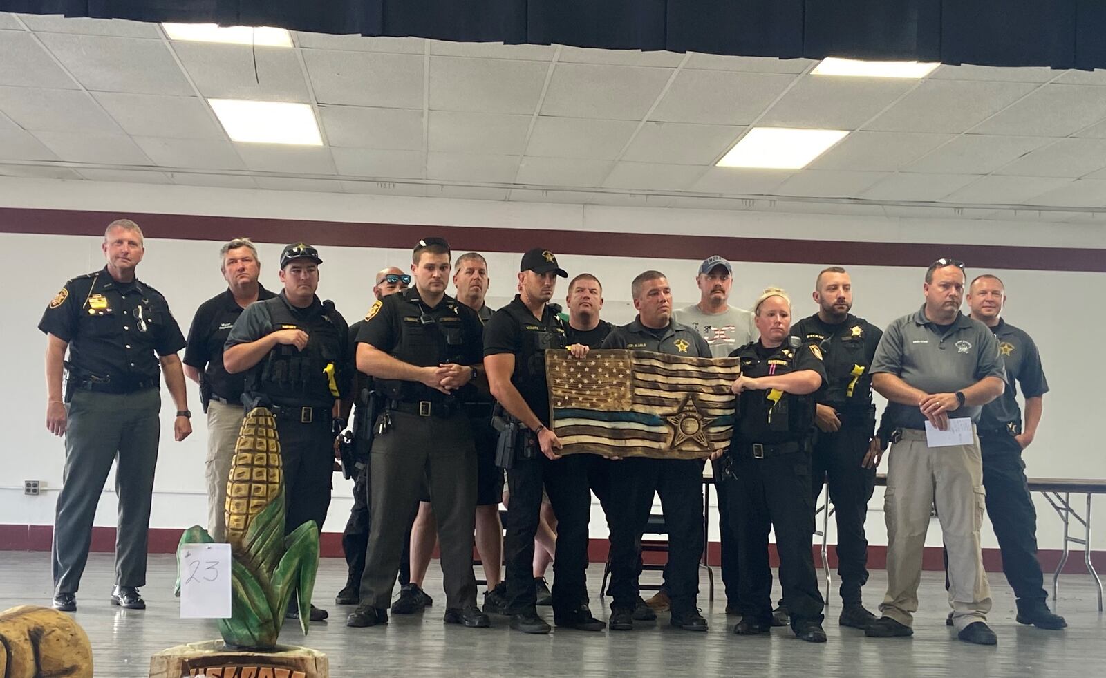 Clark County Sheriff's Office employees stand with a wood carving created to honor Deputy Matt Yates Thursday evening. Photo provided by Dean Blair.