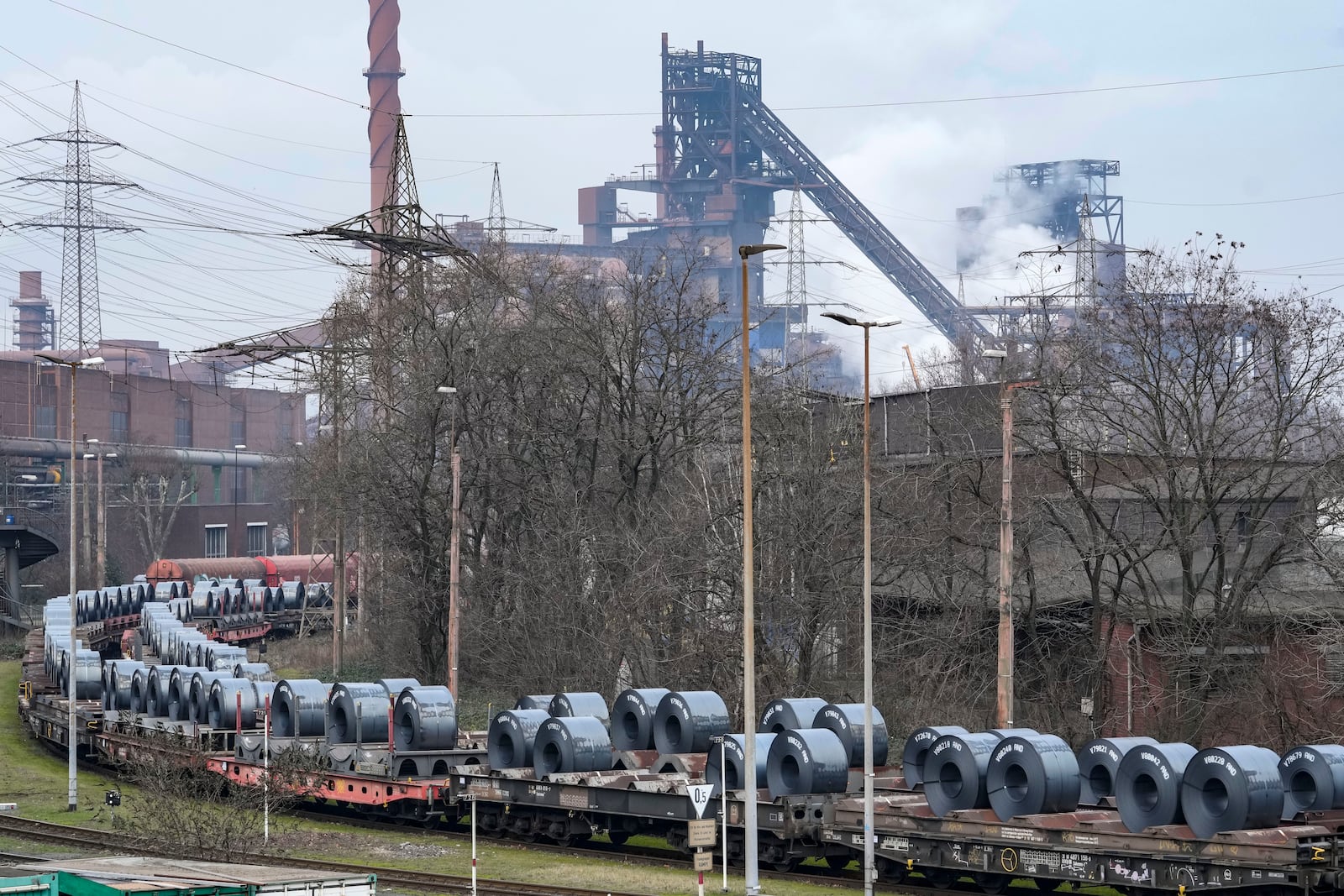 FILE - Steel on coil cars ahead of transport at the main factory of struggling steel producer thyssenkrupp in Duisburg, Germany, Tuesday, Feb. 4, 2025. (AP Photo/Martin Meissner, File)