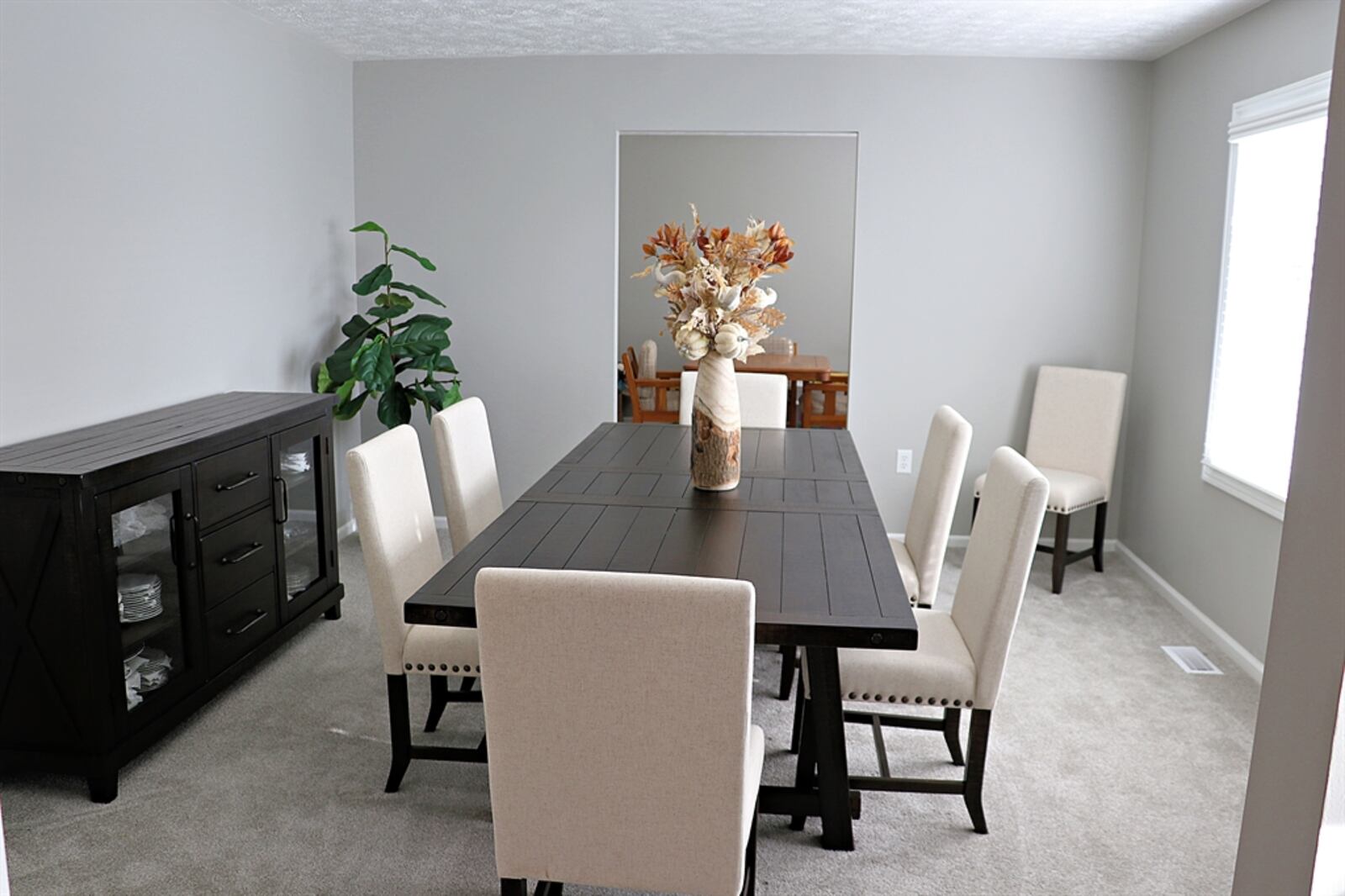 This formal dining room flows into a smaller space that is the original dining room, which is accessible to the kitchen.