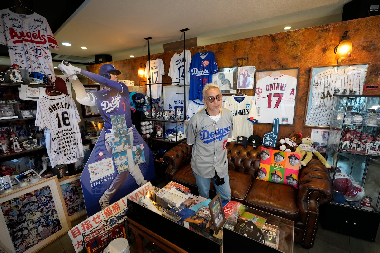 Hironobu Kanno, representative of a private fan club of Shohei Ohtani of the Los Angeles Dodgers, shows his collection items at his beauty salon in Oshu, northeastern Japan, the hometown of Ohtani, Tuesday, Oct. 29, 2024. (AP Photo/Eugene Hoshiko)