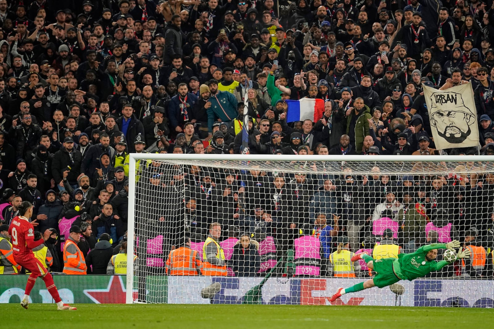 PSG's goalkeeper Gianluigi Donnarumma saves a penalty from Liverpool's Darwin Nunez during a shootout at the end of the Champions League round of 16 second leg soccer match between Liverpool and Paris Saint-Germain at Anfield in Liverpool, England, Tuesday, March 11, 2025. (AP Photo/Dave Thompson)