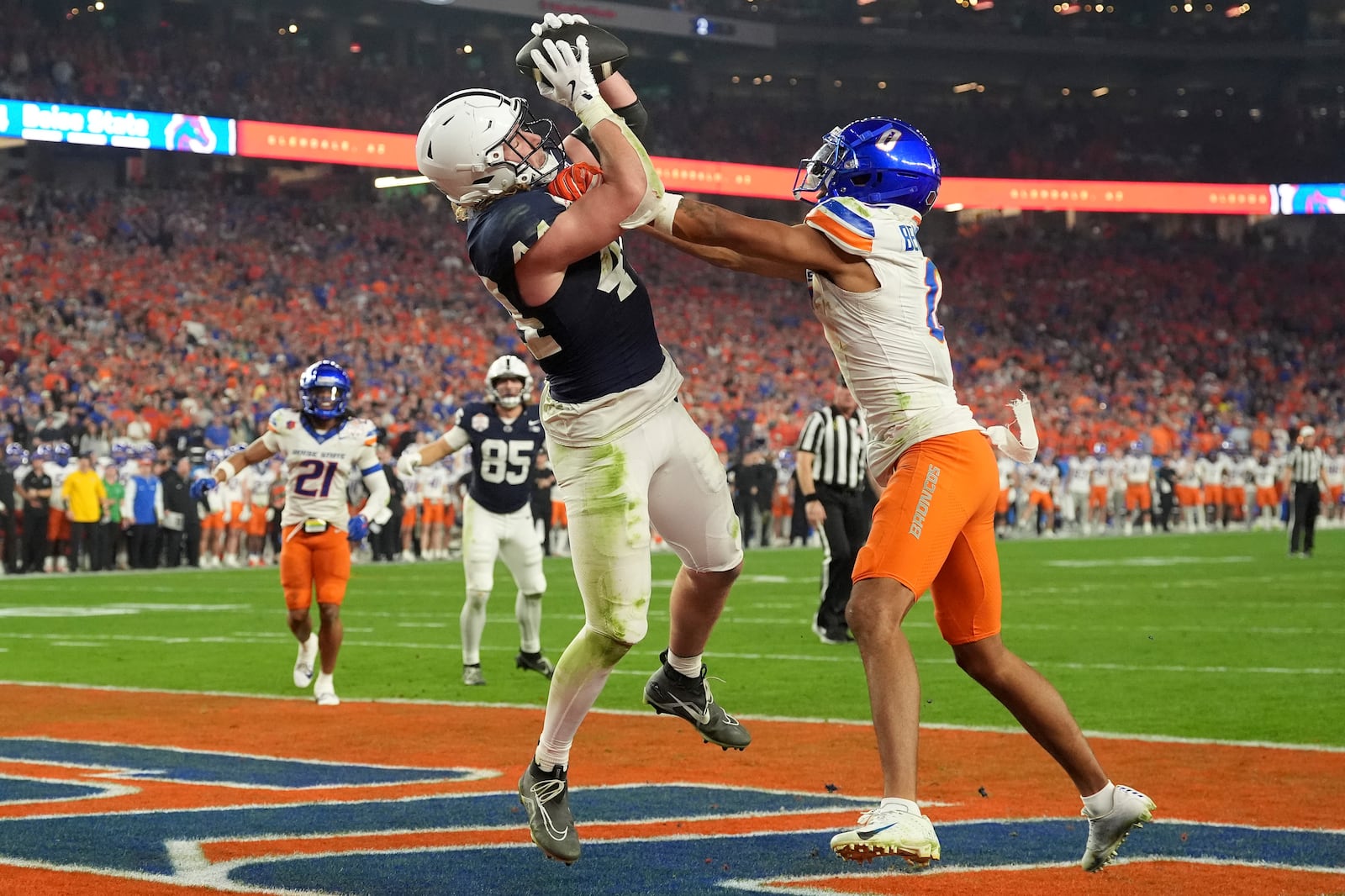 Penn State tight end Tyler Warren (44) pulls in a touchdown pass as Boise State safety Ty Benefield (0) defends during the second half of the Fiesta Bowl College Football Playoff game, Tuesday, Dec. 31, 2024, in Glendale, Ariz. (AP Photo/Ross D. Franklin)