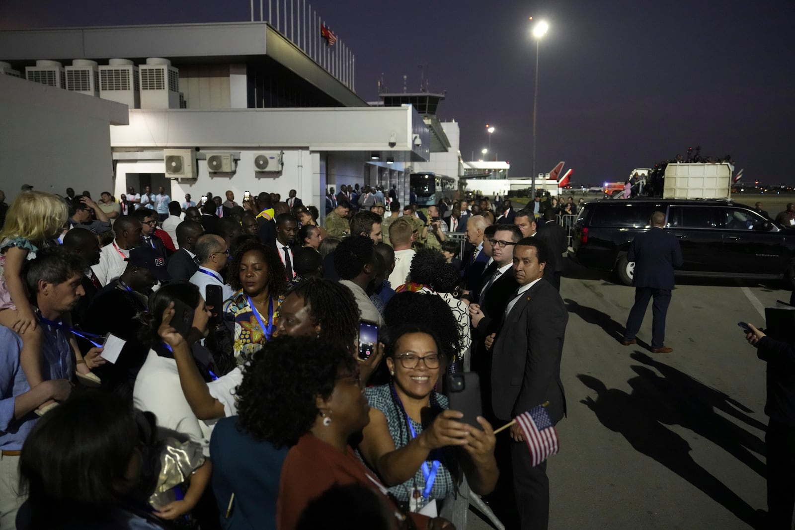 President Joe Biden greets well wishers as he arrives at Quatro de Fevereiro international airport in the capital Luanda, Angola on Monday, Dec. 2, 2024, on his long-promised visit to Africa. (AP Photo/Ben Curtis)