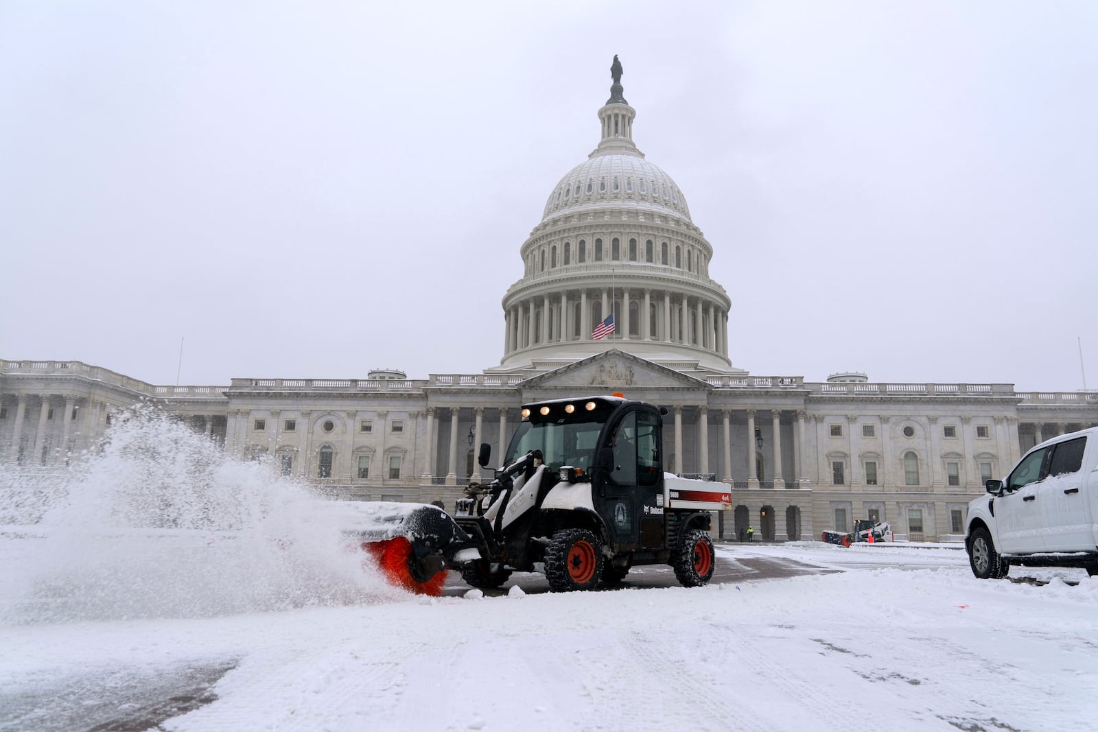 A snowplow clears the area as snow blankets Capitol Hill ahead of a joint session of Congress to certify the votes from the Electoral College in the presidential election in Washington, Monday, Jan. 6, 2025. (AP Photo/Jose Luis Magana)