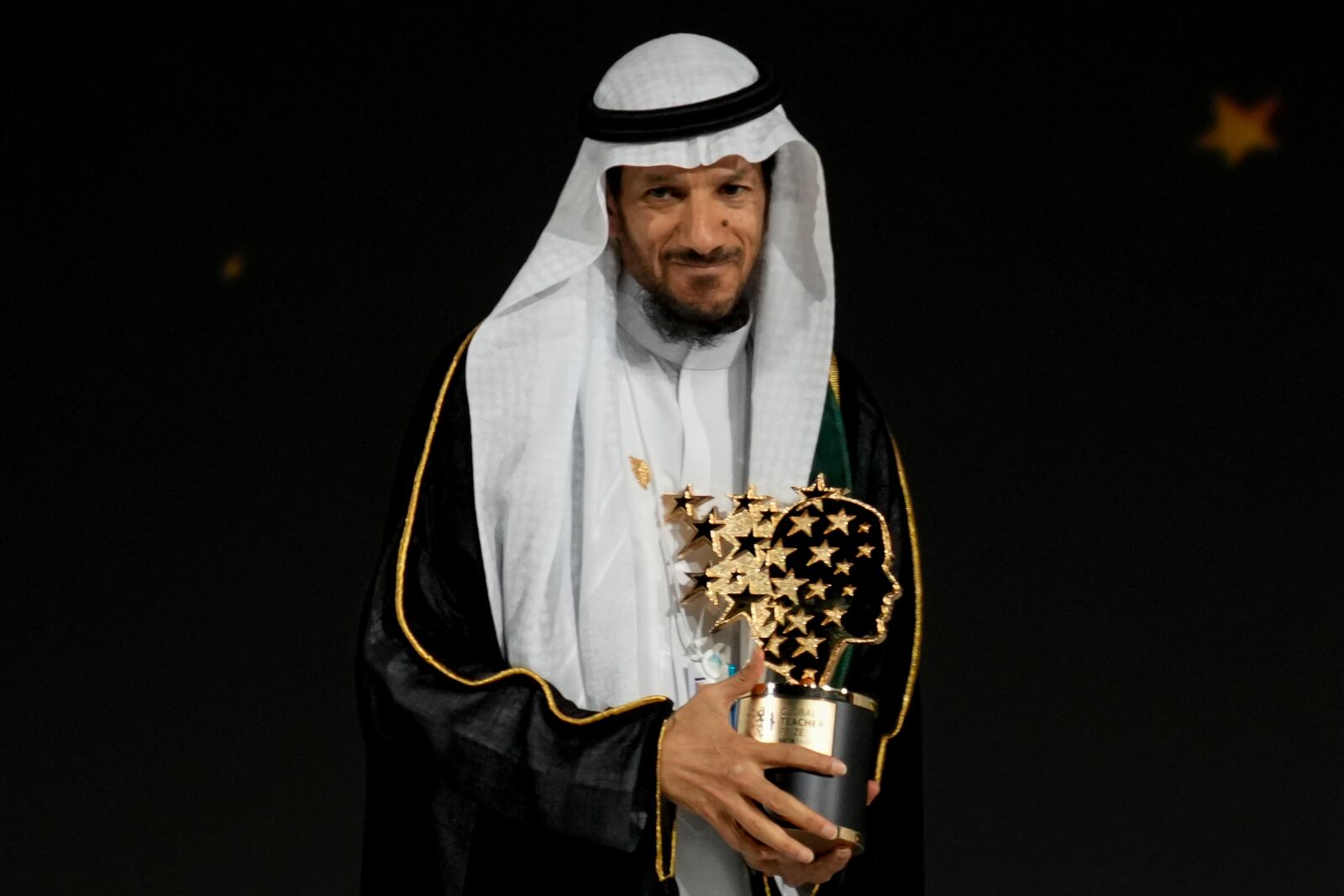 Saudi Arabian teacher Mansour bin Abdullah Al-Mansour, poses with the Global Teacher Prize trophy at a ceremony in Dubai, United Arab Emirates, Thursday, Feb. 13, 2025. (AP Photo/Altaf Qadri)