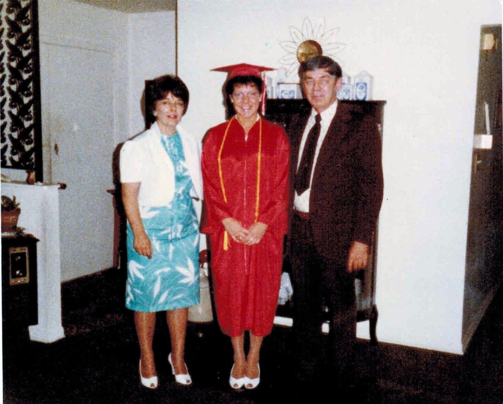 Kay Plzak Fuhrman, center, at her high school graduation with her parents Romelle and Jerry. They lived in the same house they built in 1965 until their deaths. CONTRIBUTED