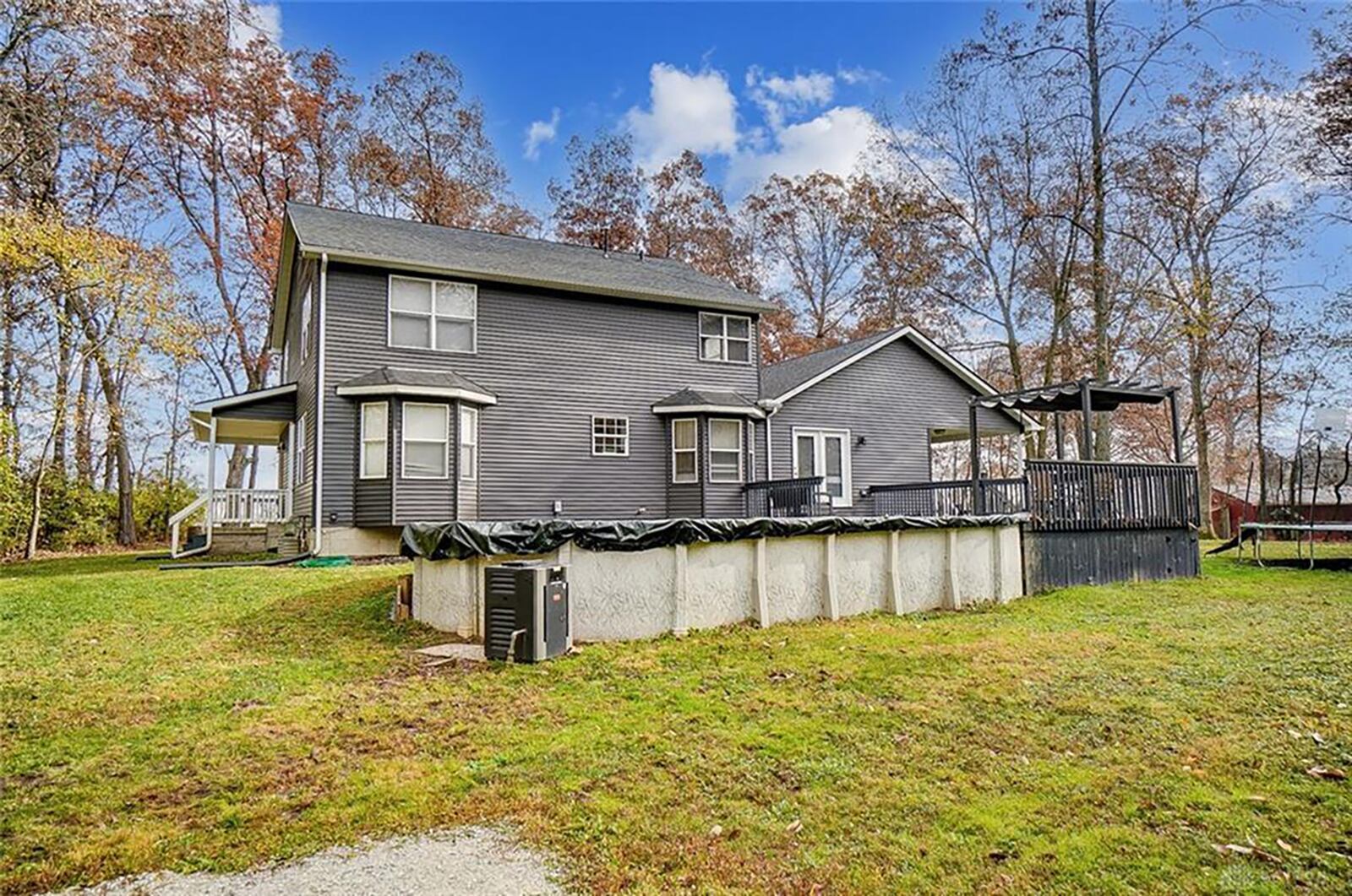 The rear of the home has two bay windows, an updated wood deck with pergola and above-ground pool. There is also a covered patio on the side. Contributed photo