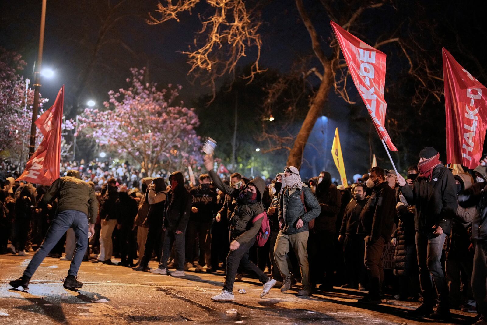 A man throws an object during clashes with police during a protest against the arrest of Istanbul's Mayor Ekrem Imamoglu in Istanbul, Turkey, Friday, March 21, 2025. (AP Photo/Emrah Gurel)