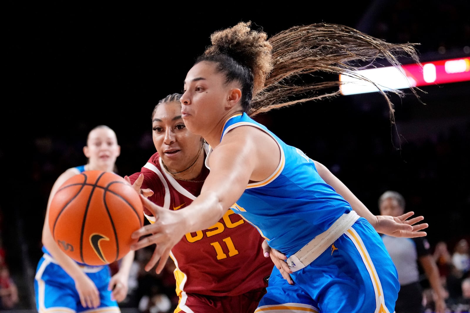 UCLA guard Kiki Rice, right, dribbles as Southern California guard Kennedy Smith defends during the first half of an NCAA college basketball game, Thursday, Feb. 13, 2025, in Los Angeles. (AP Photo/Mark J. Terrill)