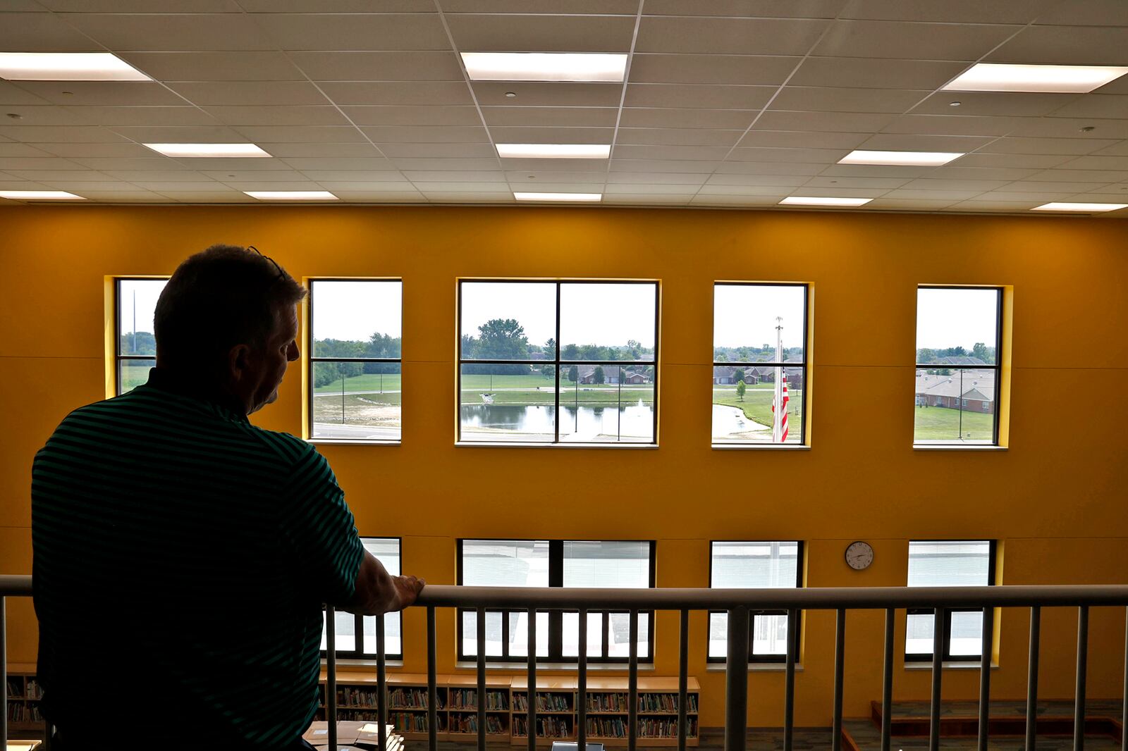 Northeastern Superintendent John Kronour looks over the library in the new Kenton Ridge School. BILL LACKEY/STAFF