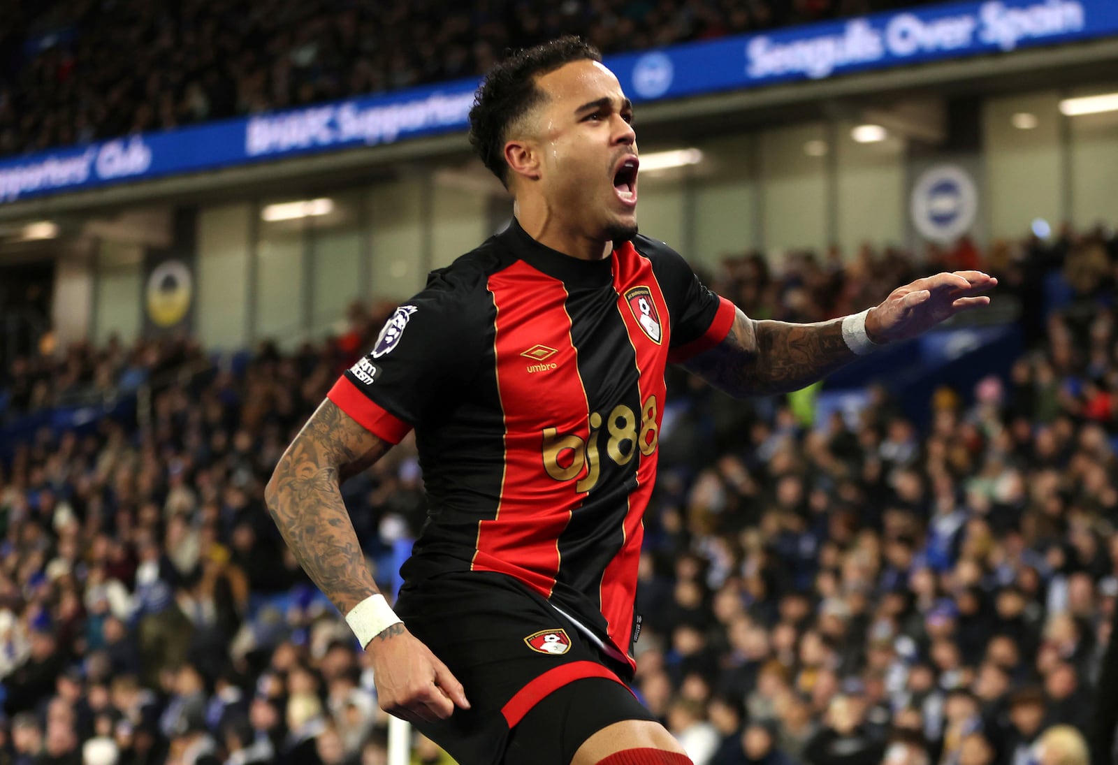 Bournemouth's Justin Kluivert celebrates scoring their side's first goal of the game during the English Premier League soccer match at American Express Stadium, Brighton, England, Tuesday, Feb. 25, 2025. (Steven Paston/PA via AP)