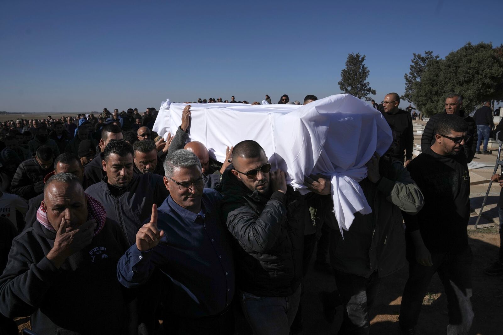 Members of the Bedouin community carry the body of Yosef Al Zaydani, who was in Hamas captivity in the Gaza Strip, a day after the Israeli army said his body was recovered in an underground tunnel in southern Gaza, during his funeral in Rahat, southern Israel, Thursday, Jan. 9, 2025. (AP Photo/Mahmoud Illean)