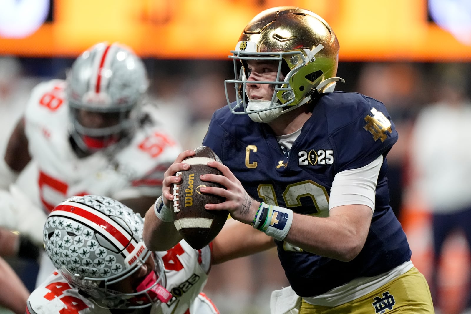 Notre Dame quarterback Riley Leonard is tackled by Ohio State defensive end JT Tuimoloau during first half of the College Football Playoff national championship game Monday, Jan. 20, 2025, in Atlanta. (AP Photo/Brynn Anderson)