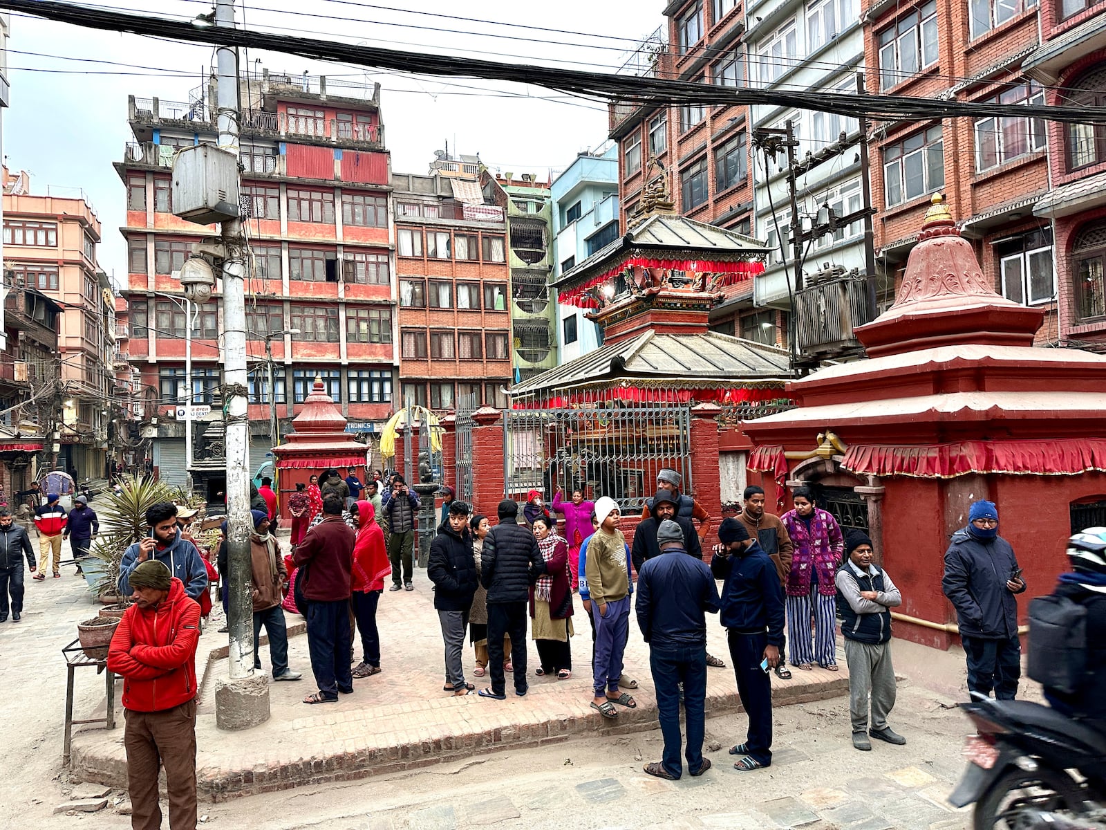 Nepalese people stand after rushing out of their homes after experiencing an earthquake in Kathmandu, Nepal, Tuesday, Jan.7, 2025. (AP Photo/Sunil Sharma)