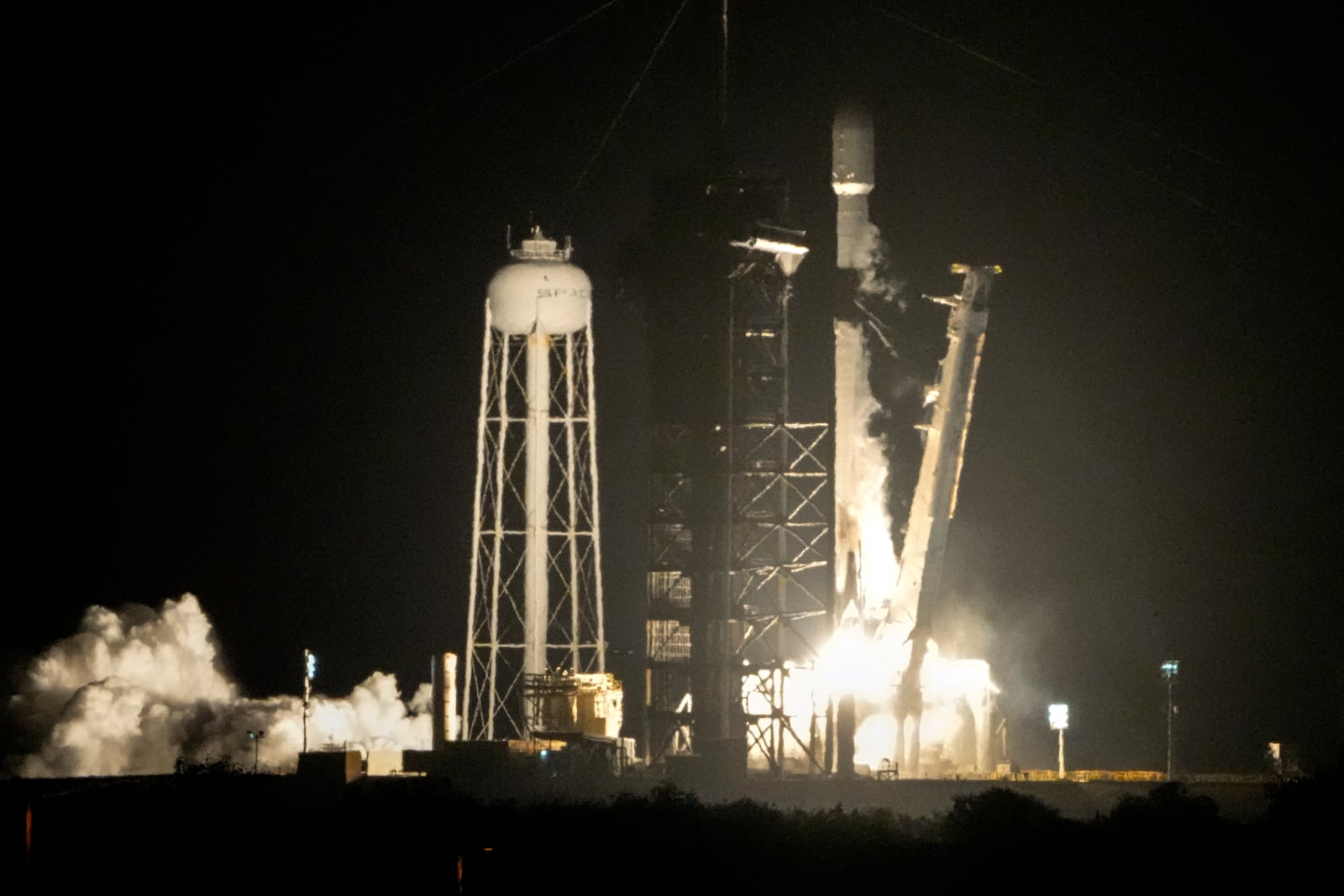 A SpaceX Falcon 9 rocket lifts off from pad 39A with a payload of a pair of lunar landers at the Kennedy Space Center in Cape Canaveral, Fla., Wednesday, Jan. 15, 2025. (AP Photo/John Raoux)