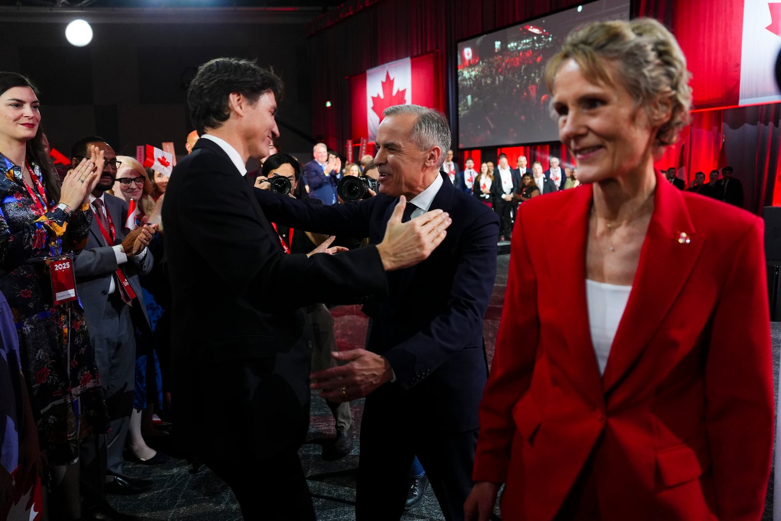 Liberal Party of Canada Leader Mark Carney, center right, speaks to Canada's Prime Minister Justin Trudeau after Carney was announced as the winner of the party leadership at the announcement event in Ottawa, Ontario, Sunday, March 9, 2025. (Sean Kilpatrick/The Canadian Press via AP)