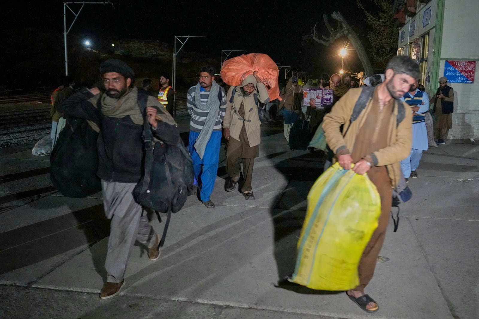 Passengers rescued by security forces from a passenger train attacked by insurgents arrive at a railway station in Much, Pakistan's southwestern Balochistan province, Thursday March 13, 2025. (AP Photo/Anjum Naveed)