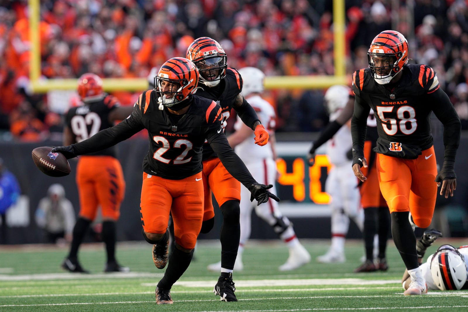 Cincinnati Bengals safety Geno Stone (22) celebrates with teammates after an interception during the second half of an NFL football game against the Cleveland Browns, Sunday, Dec. 22, 2024, in Cincinnati. (AP Photo/Jeff Dean)