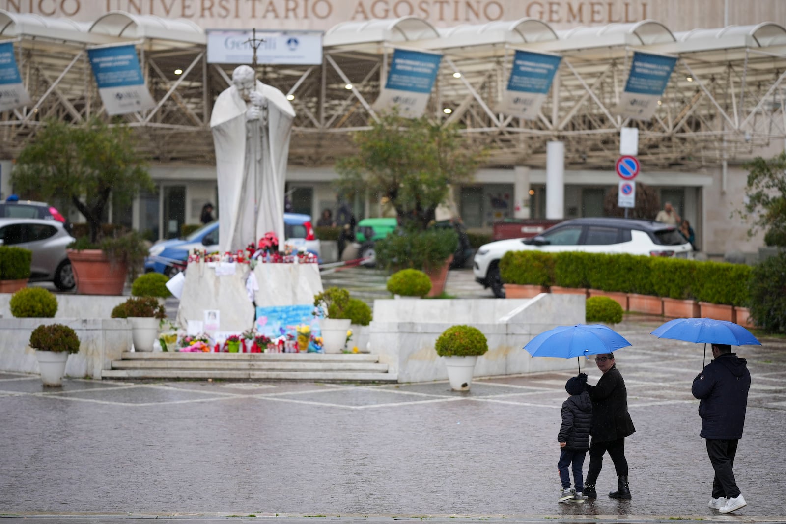 People arrive at the Agostino Gemelli Polyclinic, in Rome, Saturday, March 1, 2025, where Pope Francis has been hospitalized since Friday, Feb. 14. (AP Photo/Andrew Medichini)