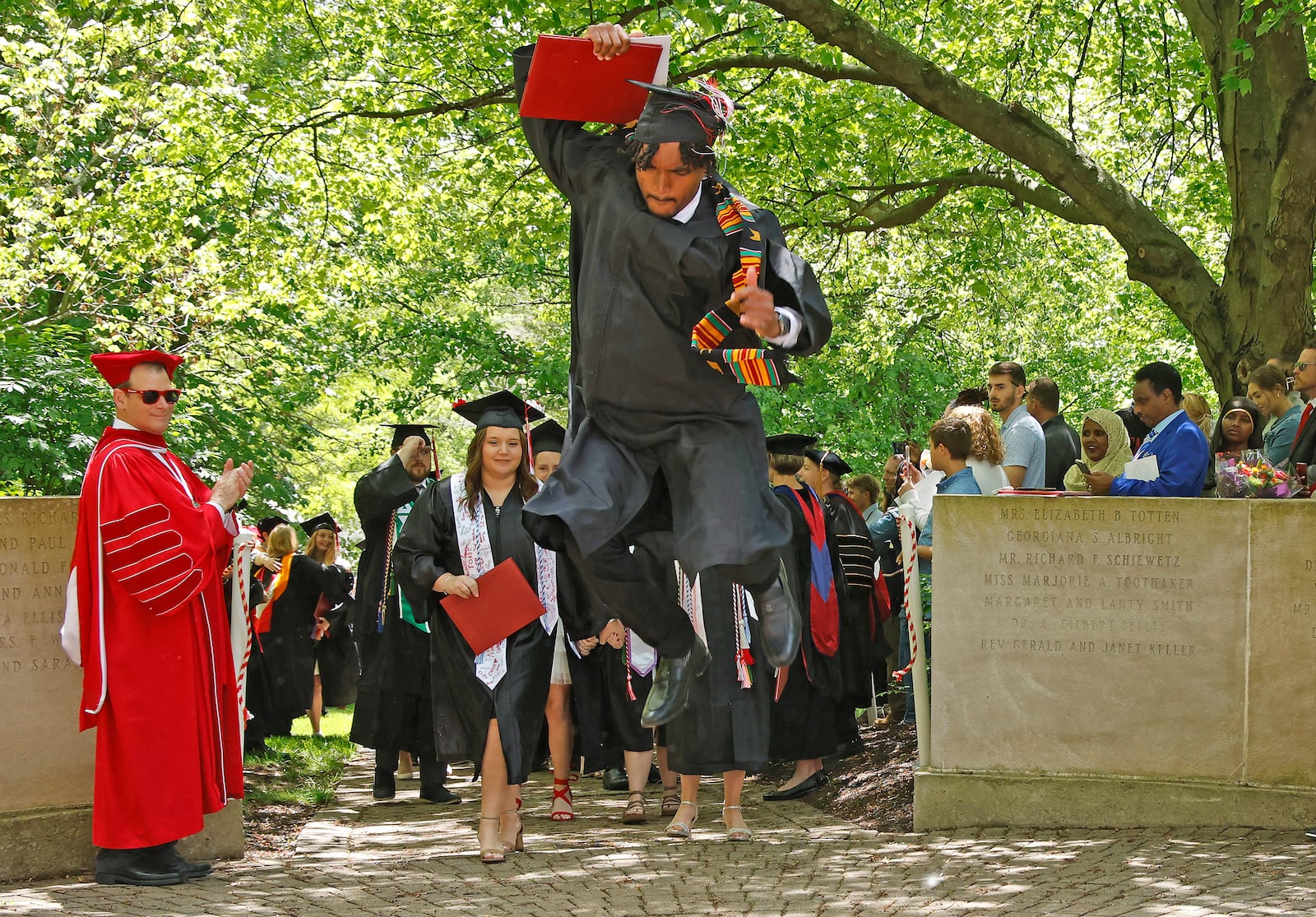 Wittenberg University graduates participate in the Stomp the Seal tradition Saturday, May 11, 2024 following the school's 174th commencement ceremony. BILL LACKEY/STAFF