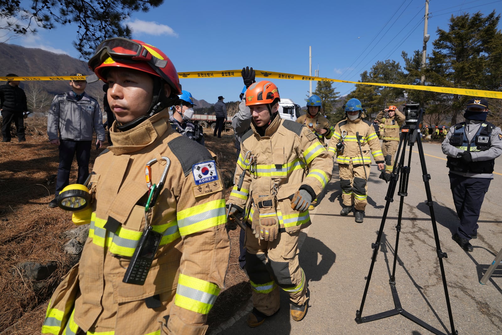 South Korea firefighters move near a bomb accident site where a South Korean fighter jet accidentally dropped bombs on a civilian area during training, in Pocheon, South Korea, Thursday, March 6, 2025. (AP Photo/Lee Jin-man)