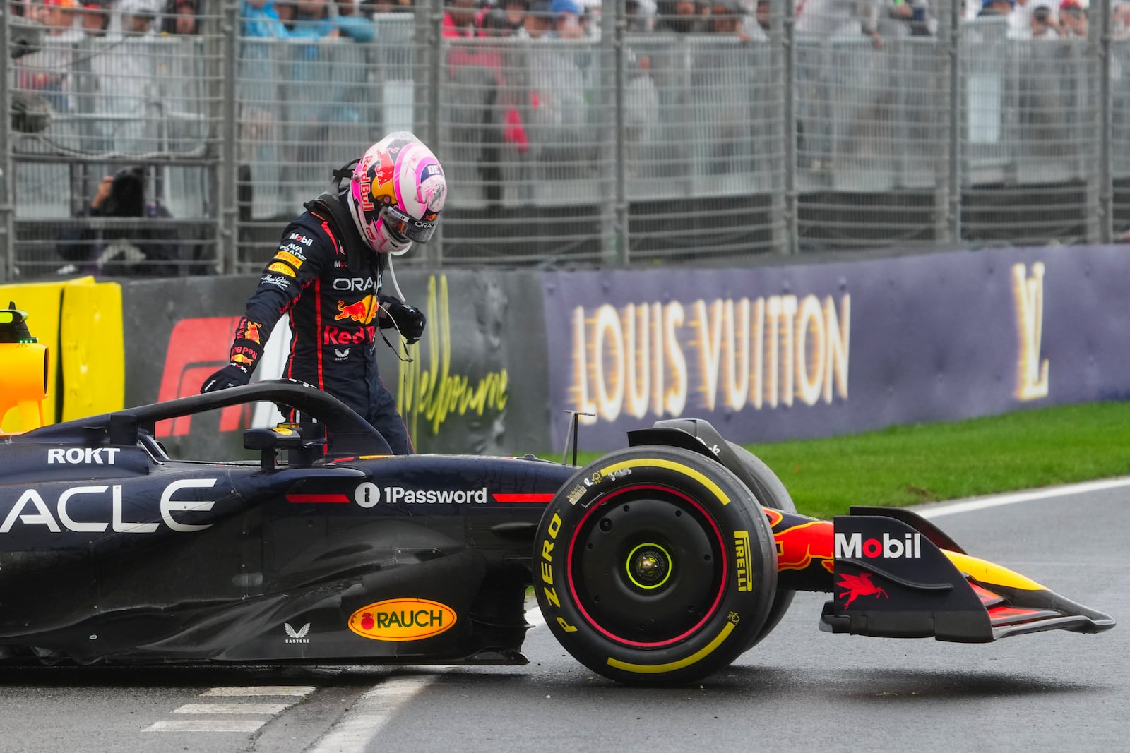 Red Bull driver Liam Lawson of New Zealand stands by his car after crashing during the Australian Formula One Grand Prix at Albert Park, in Melbourne, Australia, Sunday, March 16, 2025. (AP Photo/Scott Barbour)