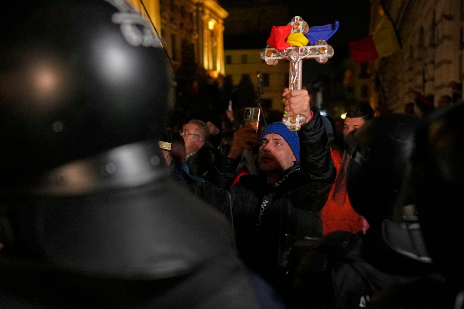 A supporter of Calin Georgescu reacts during a protest after Romania's electoral body rejected his candidacy in the presidential election rerun in Bucharest, Romania, Sunday, March 9, 2025. (AP Photo/Vadim Ghirda)