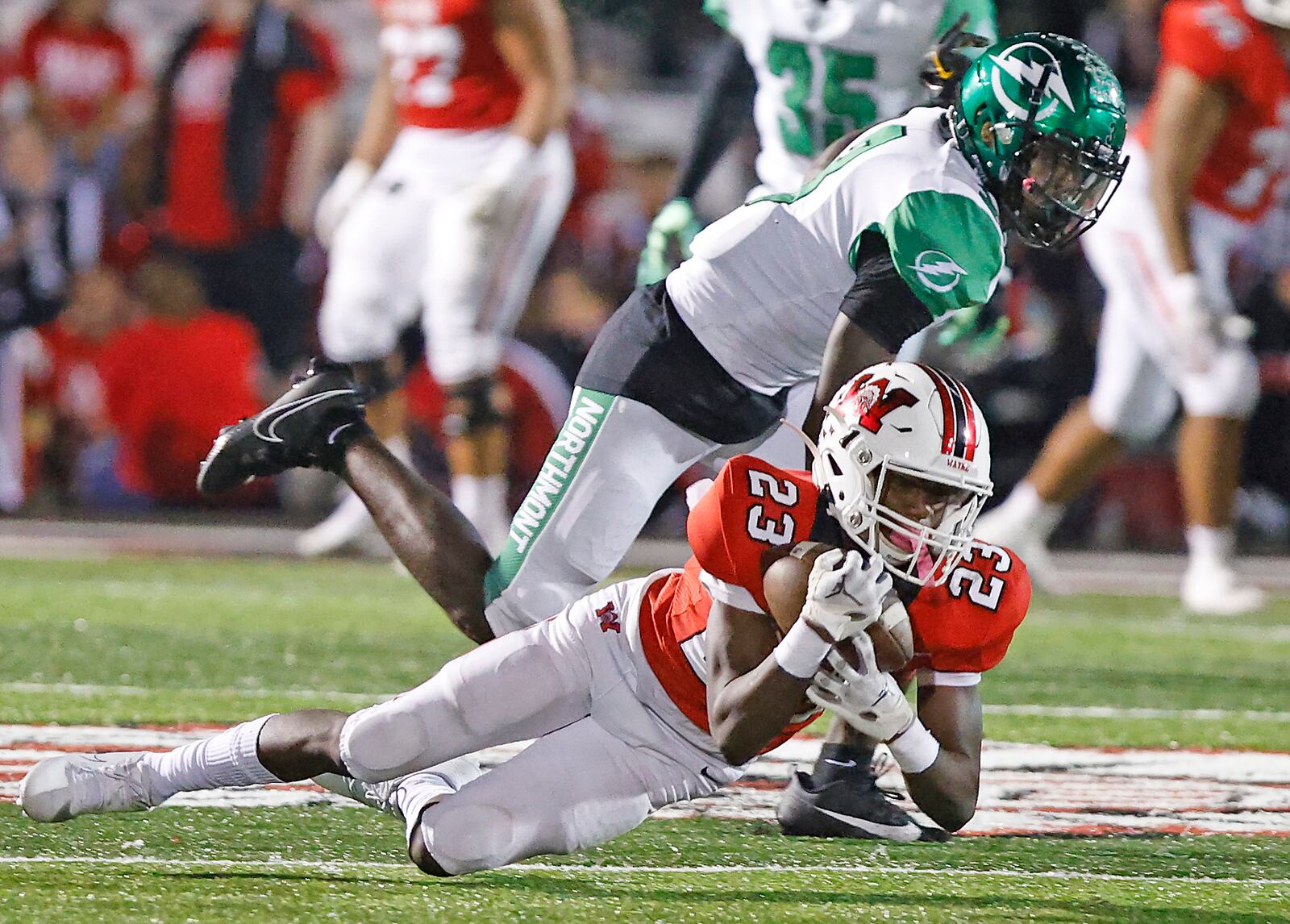 Wayne's Jamier Averette-Brown pulls in a diving catch under pressure from Northmont's Dalin Wilkins. BILL LACKEY/STAFF