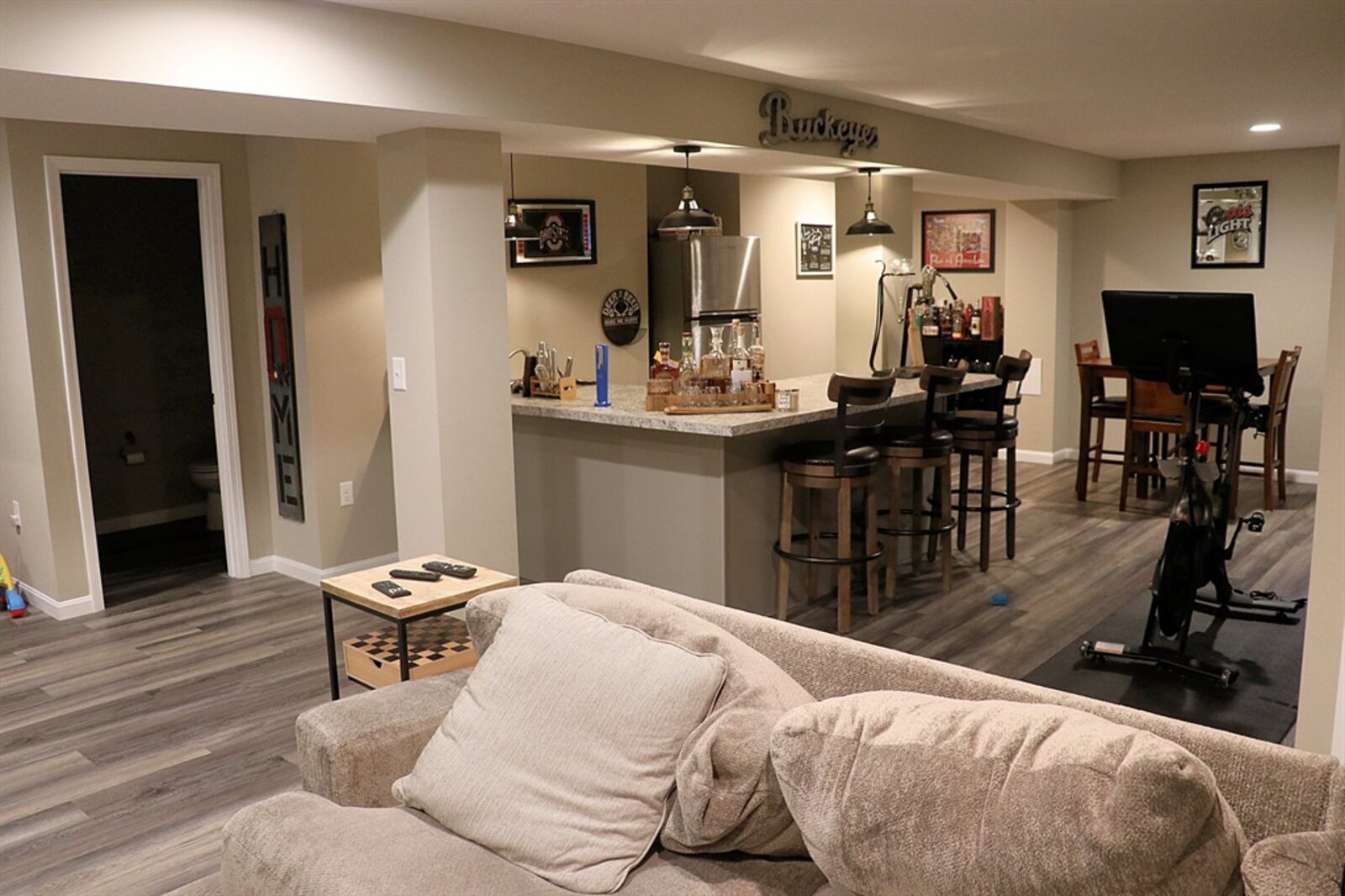 The basement has been finished into an additional 780 square feet of living space that includes a wet bar, dining area, play nook, media area, and a half bath. Luxury wood-vinyl flooring fills the entire finished space. 