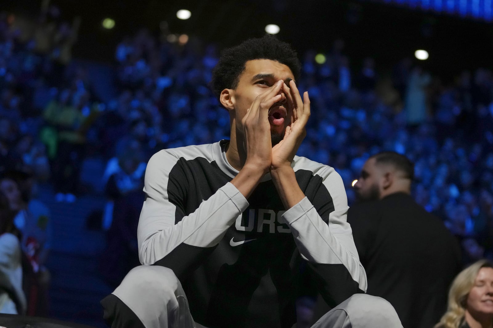 San Antonio Spurs center Victor Wembanyama gestures toward the court before a Paris Games 2025 NBA basketball game against the Indiana Pacers in Paris, Thursday, Jan. 23, 2025. (AP Photo/Thibault Camus)