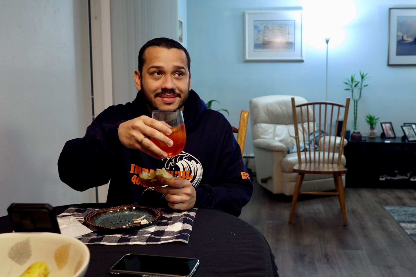 Johann Teran, a Venezuelan in the United States on humanitarian parole, eats dinner at the house of his mother-in-law, whose own legal status in the U.S. has been recently set to expire in April, at her home in Hopkins, Minn., on Thursday, Feb. 13, 2025. (AP Photo/Mark Vancleave)