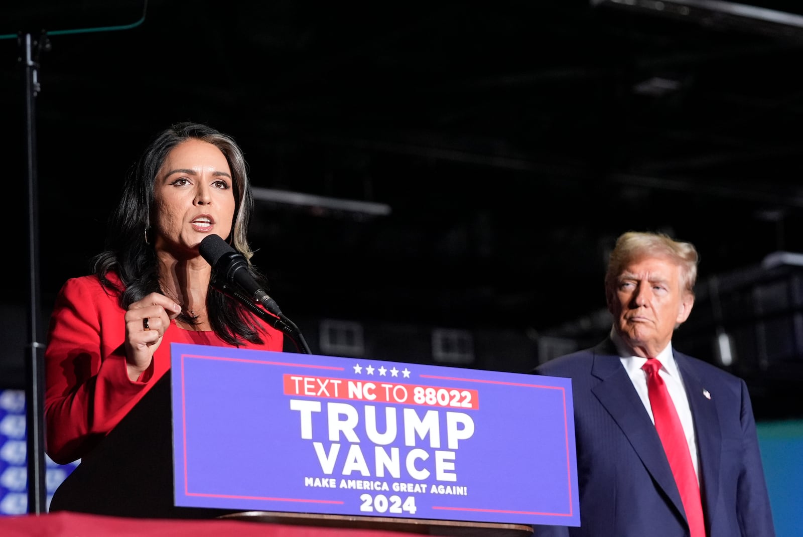 Former Democratic Rep. Tulsi Gabbard speaks as Republican presidential nominee former President Donald Trump listens during a campaign rally at Greensboro Coliseum, Tuesday, Oct. 22, 2024, in Greensboro, N.C. (AP Photo/Alex Brandon)